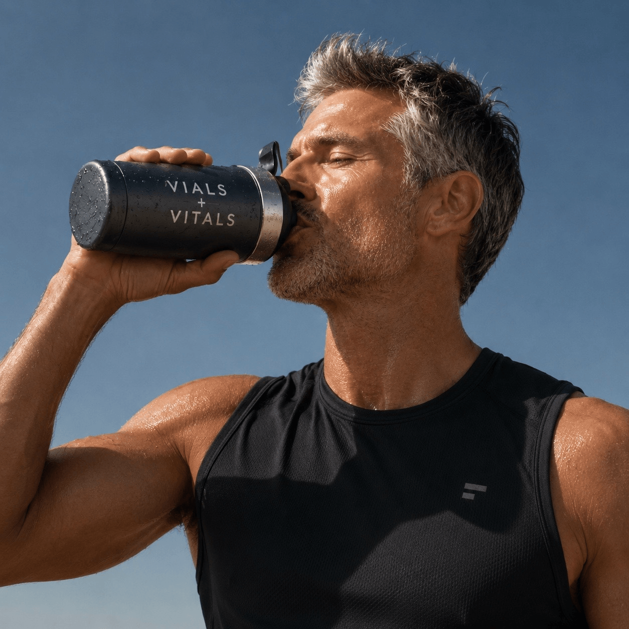 Man in his fifties hydrating after training