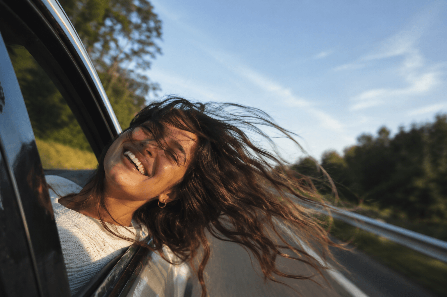 Woman laughing with the wind in her hair