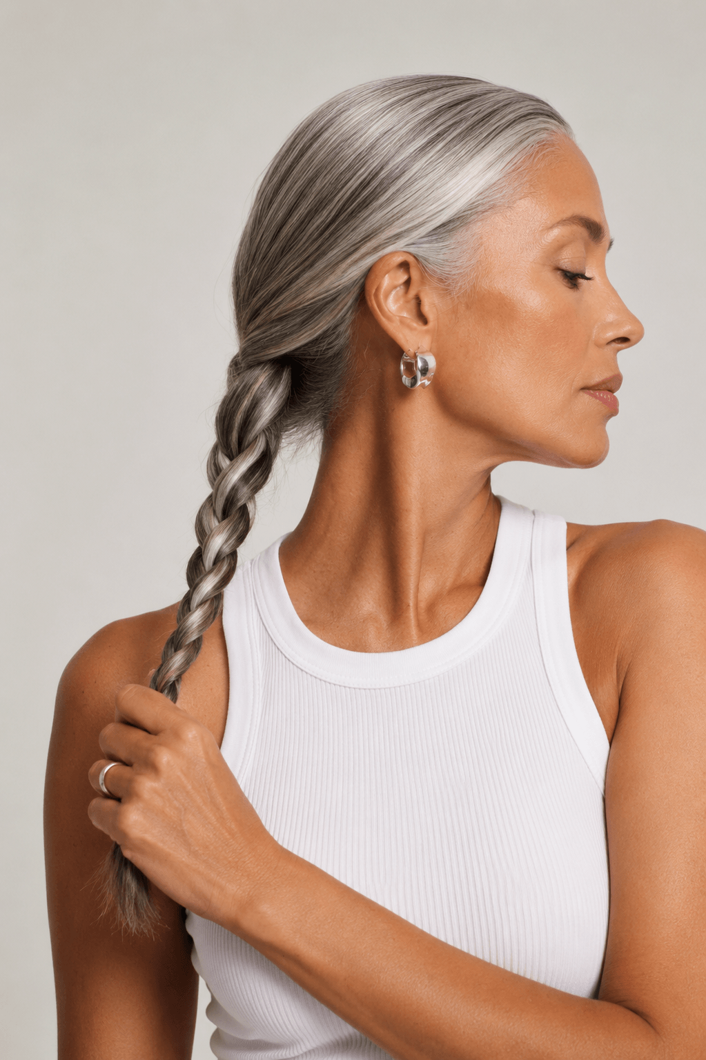 Woman holding a thick braid of healthy hair